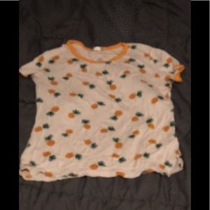 An all white T-shirt with pineapples all over it